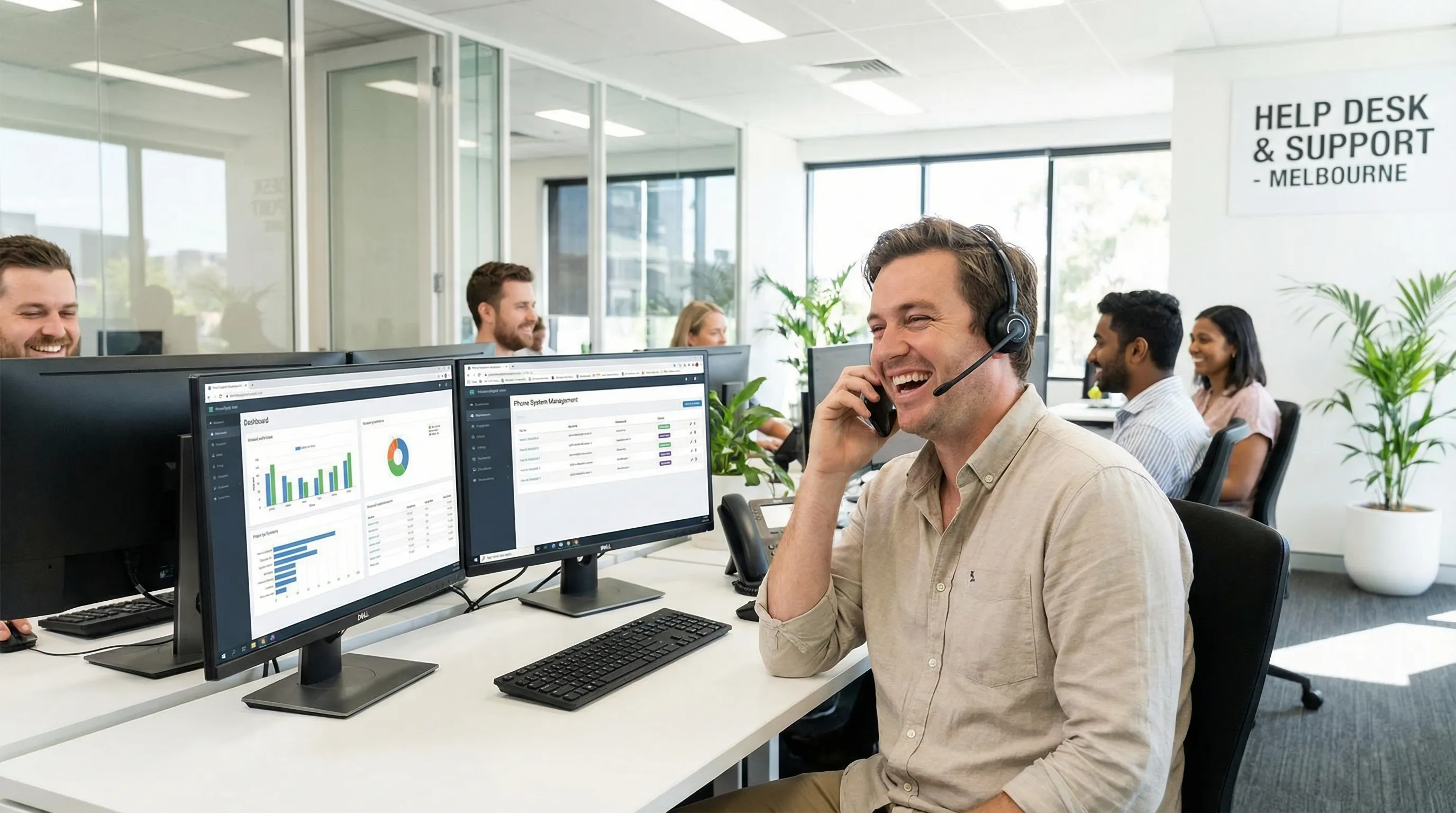 A friendly Phones Now support technician wearing a headset at their helpdesk workstation, ready to assist customers